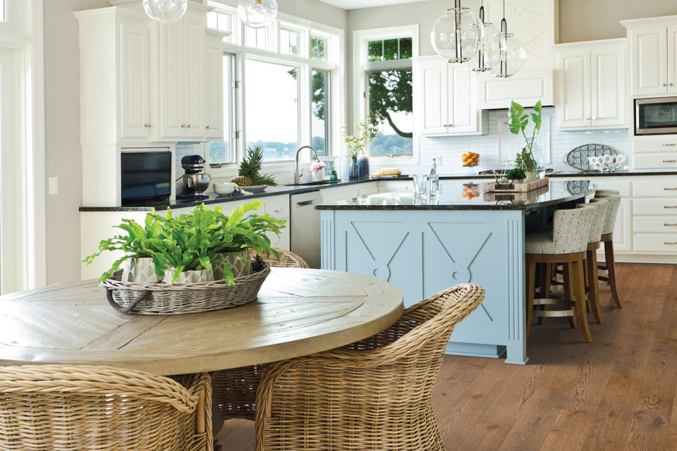 hardwood flooring in kitchen with natural furniture and decor.